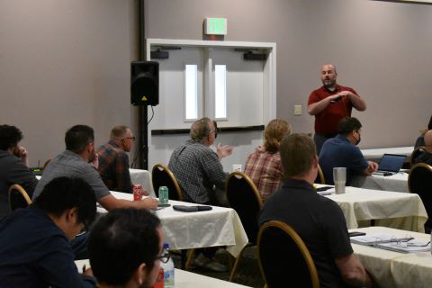 A man asks a presenter a question.