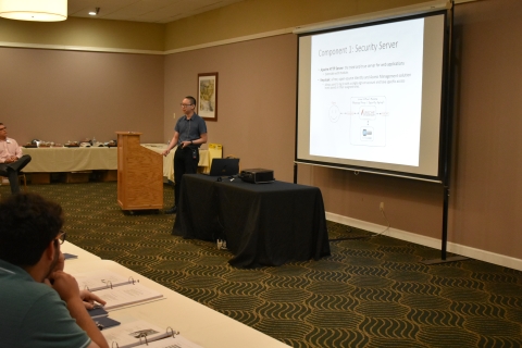 A man presents to an audience.